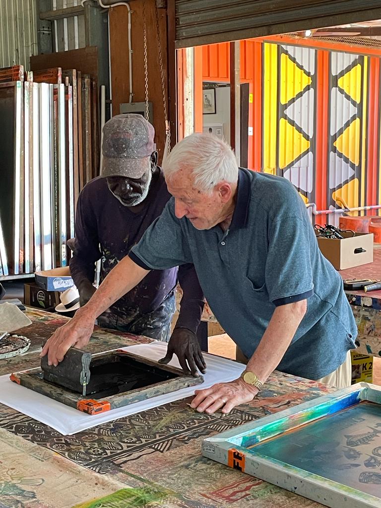 Ron Pitcher screen-printing alongside an Indigenous artist in a remote community studio